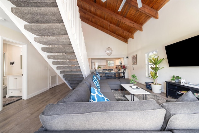 living room featuring a notable chandelier, beamed ceiling, hardwood / wood-style flooring, high vaulted ceiling, and wood ceiling