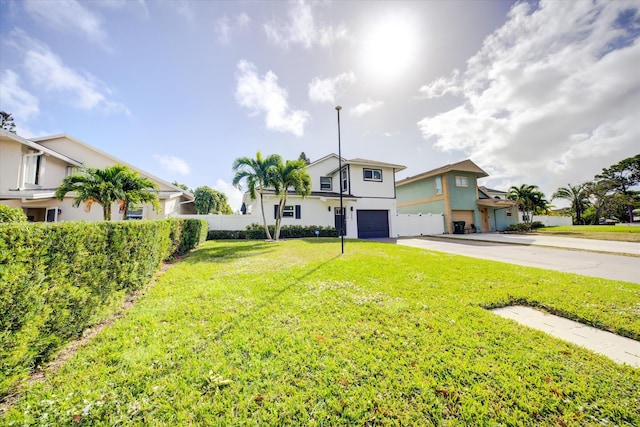 view of front facade featuring a garage and a front lawn