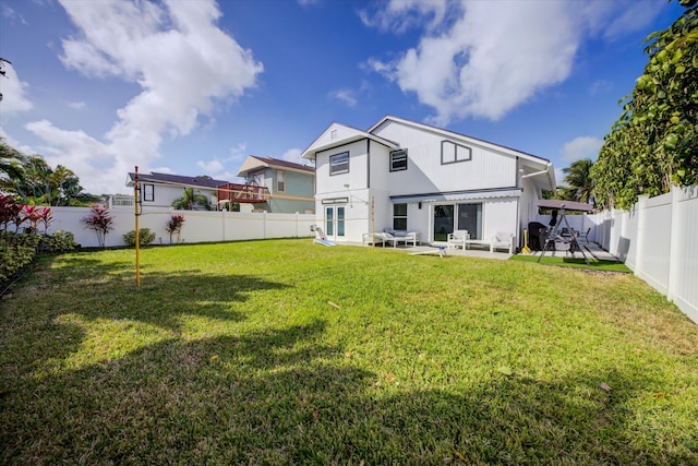 rear view of property with a patio area and a lawn