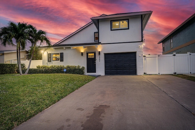 view of front facade featuring a garage and a yard