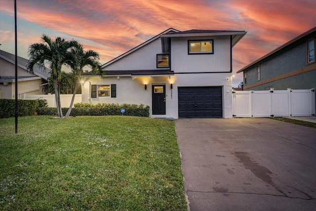 view of front of house featuring a yard and a garage