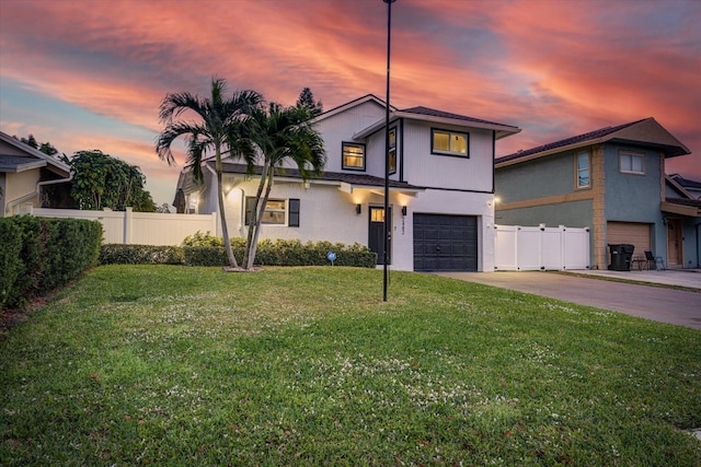 view of front of property featuring a yard and a garage