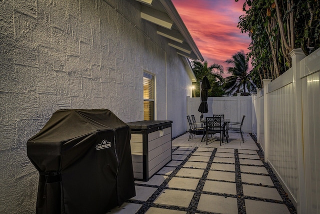 patio terrace at dusk with a grill