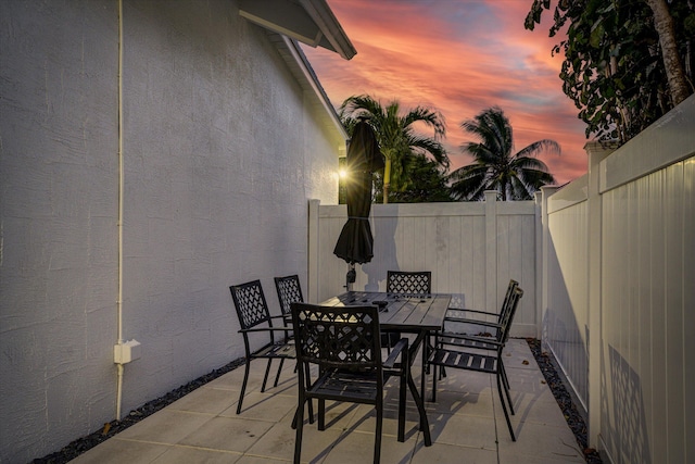 view of patio terrace at dusk