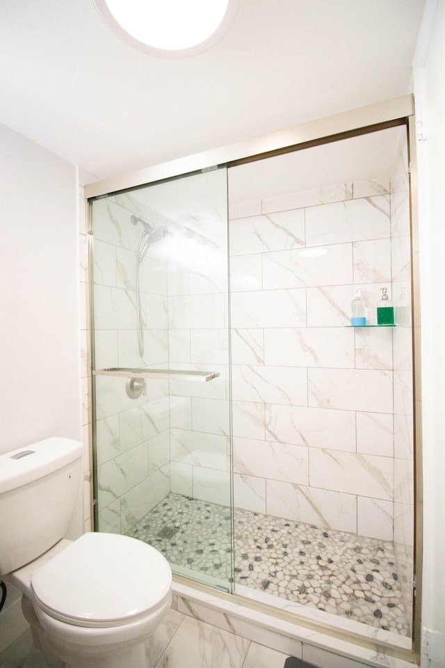 bathroom with an enclosed shower and toilet