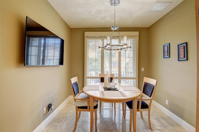 dining space featuring an inviting chandelier