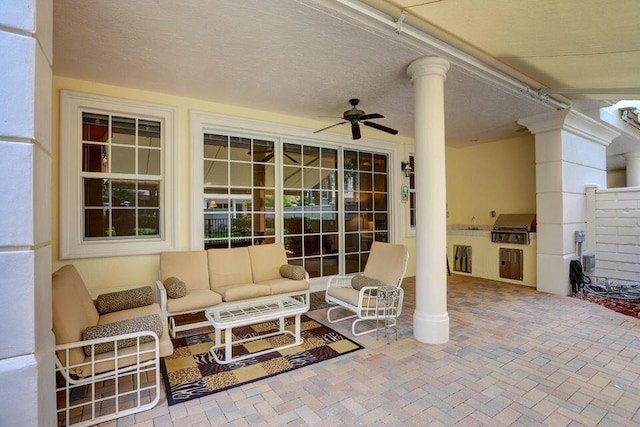 view of patio / terrace featuring an outdoor living space, an outdoor kitchen, area for grilling, and ceiling fan