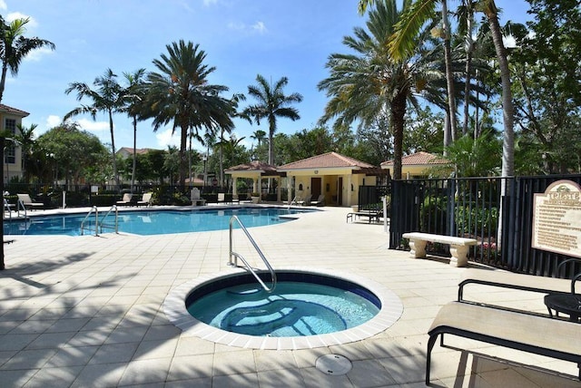 view of swimming pool with a patio area and a community hot tub