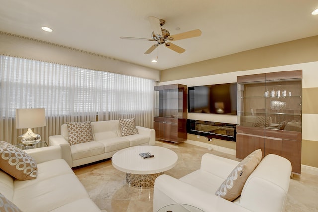 living room featuring ceiling fan and a healthy amount of sunlight