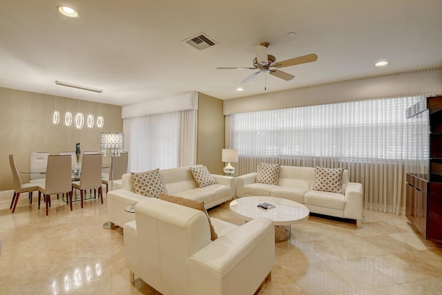 living room with plenty of natural light and ceiling fan