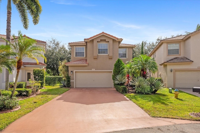 mediterranean / spanish-style house featuring a garage and a front lawn