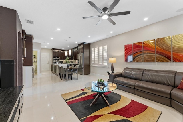 living room featuring ceiling fan and light tile patterned flooring