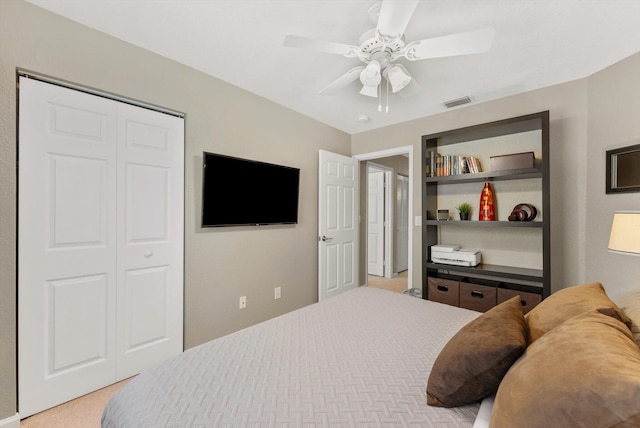 bedroom featuring light carpet, a closet, and ceiling fan