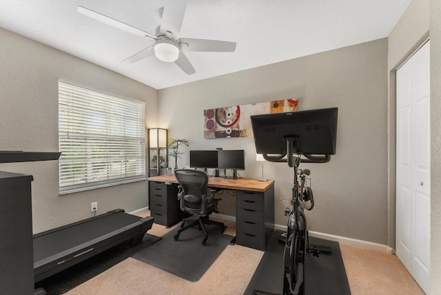 carpeted home office with ceiling fan