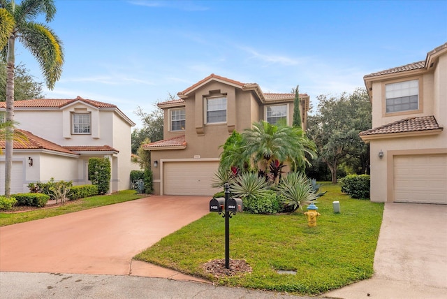 mediterranean / spanish home with a front lawn and a garage