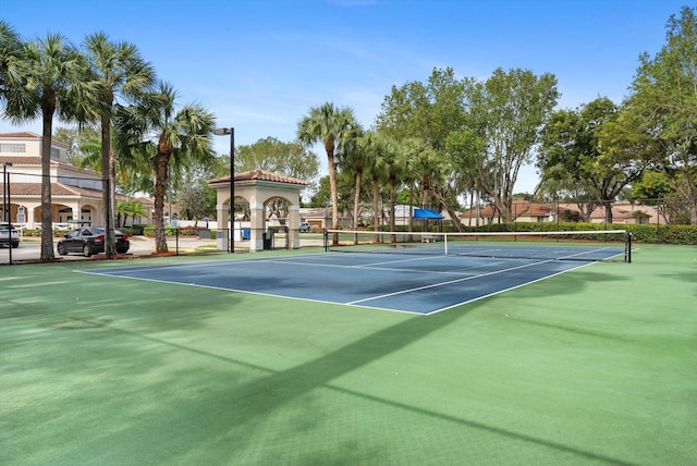 view of tennis court featuring basketball hoop