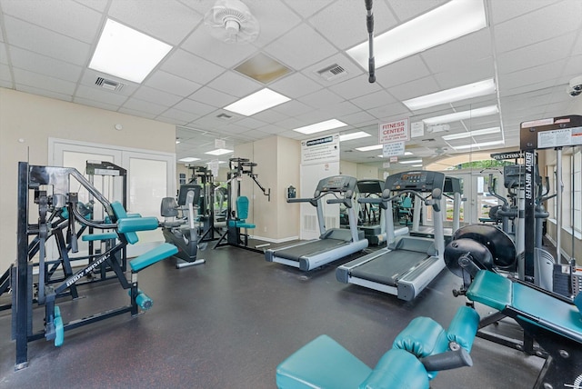 exercise room featuring a paneled ceiling