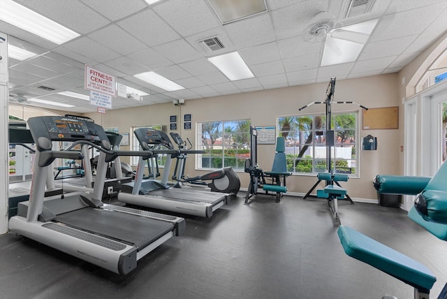 exercise room with a paneled ceiling