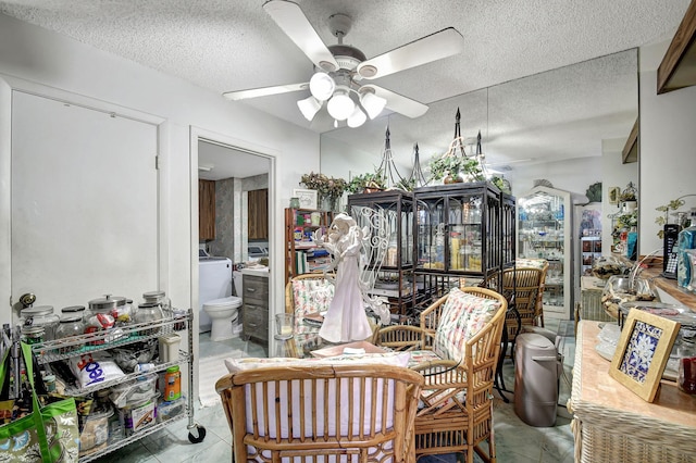 tiled dining area featuring washer / clothes dryer, ceiling fan, and a textured ceiling