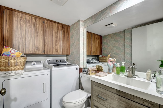 interior space featuring vanity, separate washer and dryer, and toilet