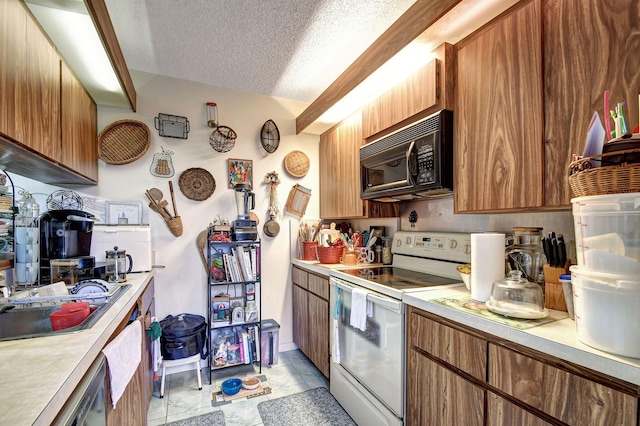 kitchen featuring a textured ceiling, light tile patterned flooring, and white electric stove