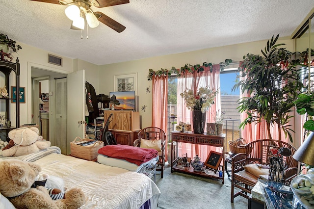 carpeted bedroom featuring a textured ceiling, a closet, and ceiling fan