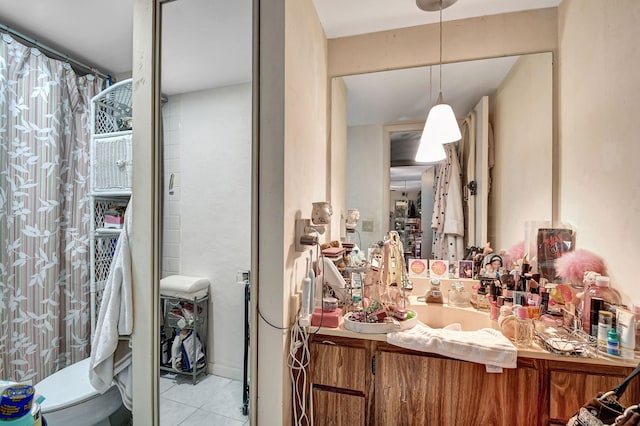 bathroom with tile patterned flooring, vanity, and toilet