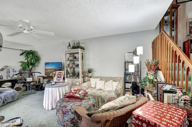 living room with carpet, ceiling fan, and a textured ceiling