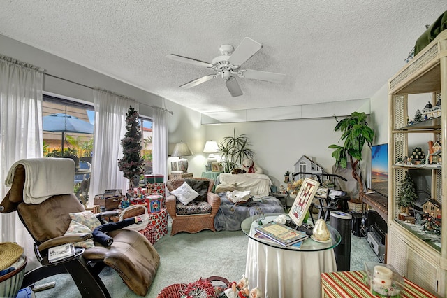 carpeted living room featuring ceiling fan and a textured ceiling