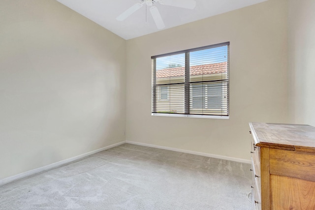 empty room featuring light colored carpet and ceiling fan