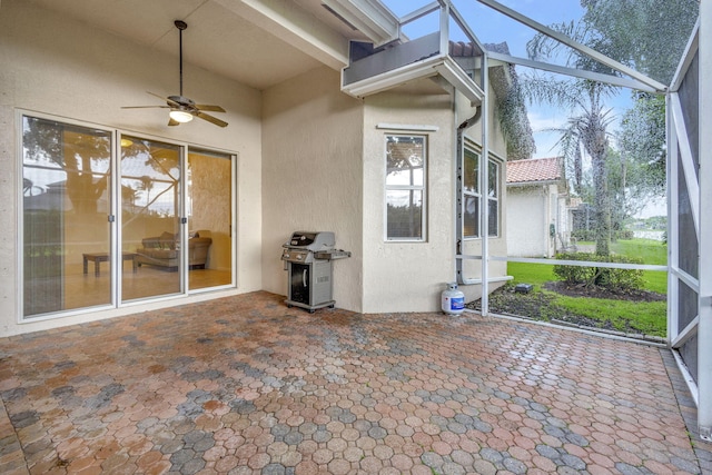 unfurnished sunroom featuring ceiling fan