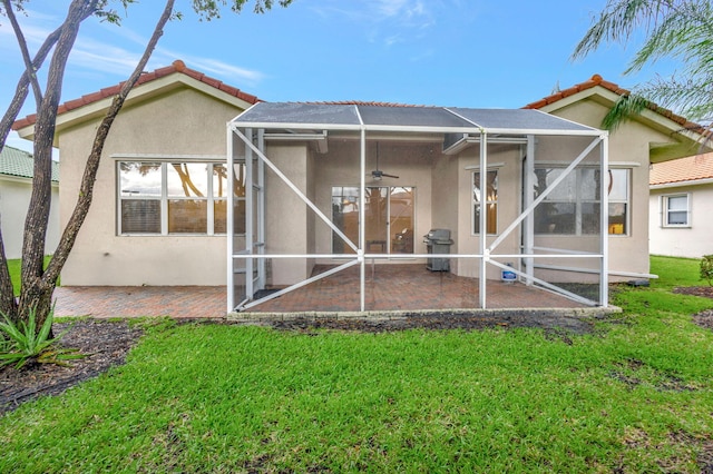 back of house with a yard, a lanai, a patio, and ceiling fan