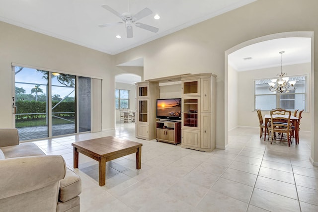 tiled living room with crown molding and ceiling fan with notable chandelier