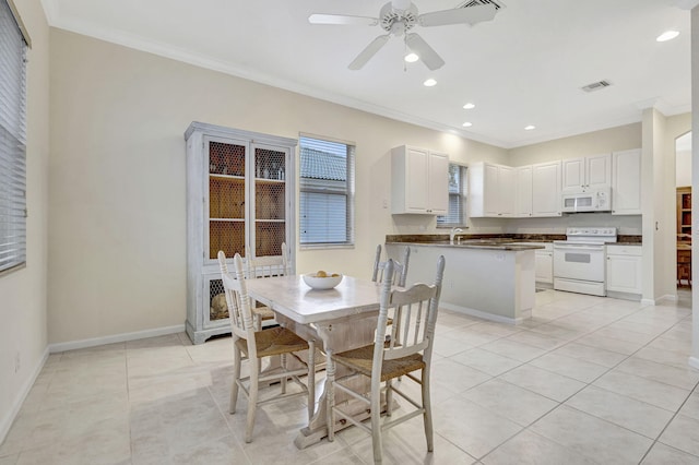 tiled dining area with crown molding and ceiling fan