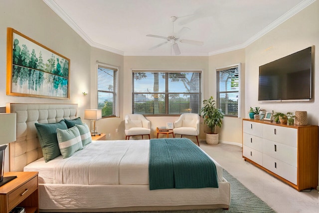 carpeted bedroom with ornamental molding and ceiling fan