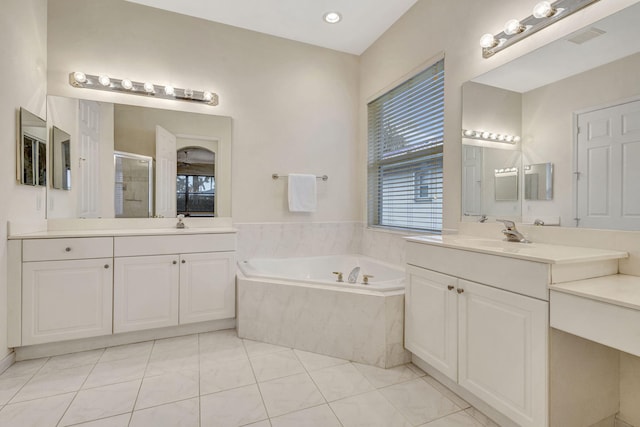 bathroom with vanity, tile patterned floors, and plus walk in shower