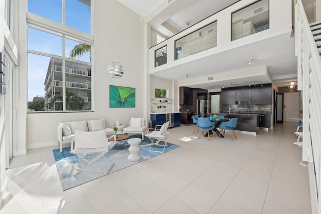 tiled living room featuring a towering ceiling