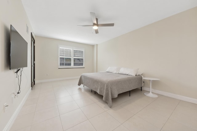 tiled bedroom featuring ceiling fan