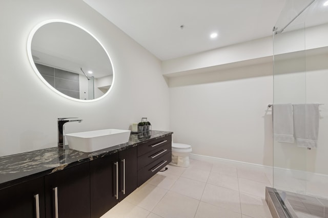 bathroom featuring tile patterned floors, vanity, and toilet