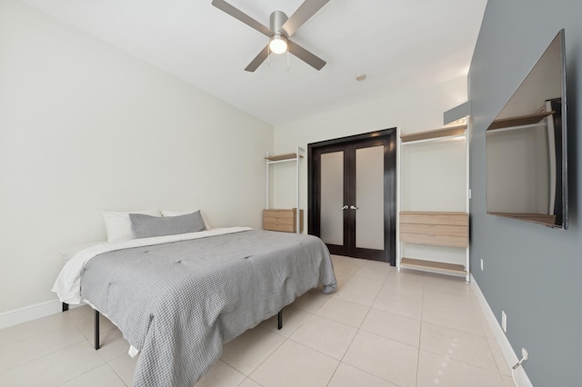 bedroom with ceiling fan and light tile patterned floors