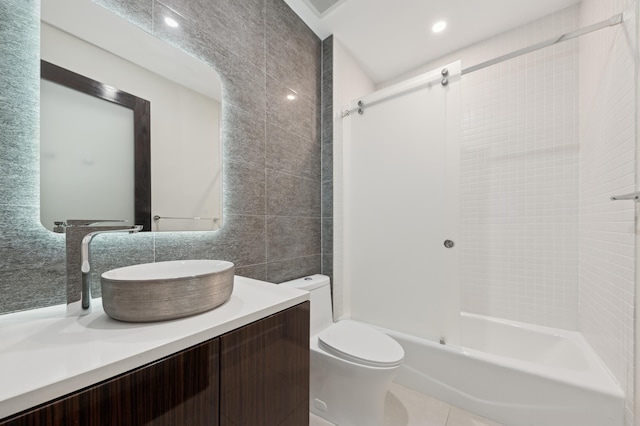 full bathroom with vanity, shower / washtub combination, tile walls, tile patterned flooring, and toilet