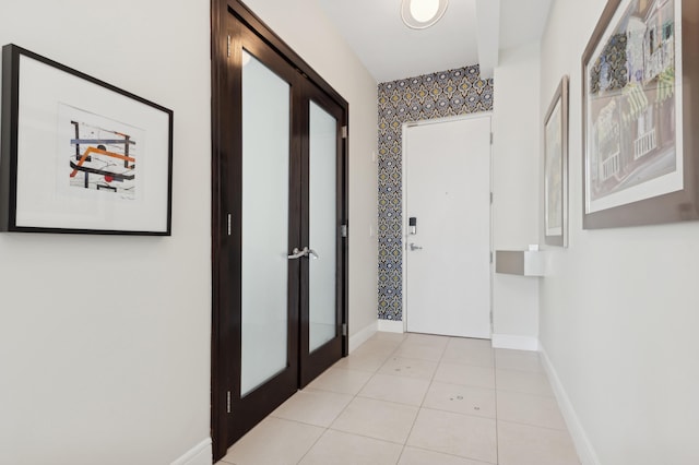 hallway with french doors and light tile patterned floors