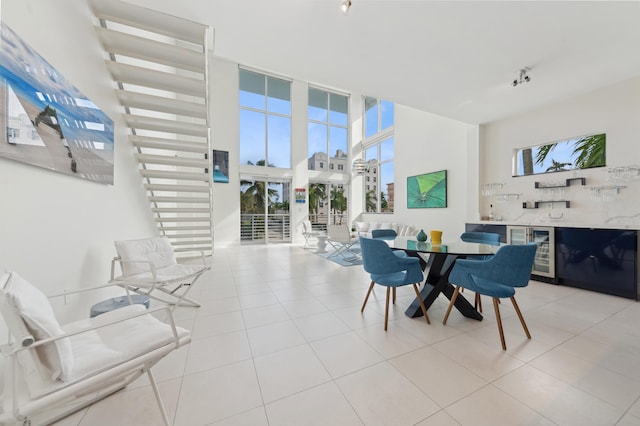 dining area featuring wine cooler, light tile patterned floors, and expansive windows