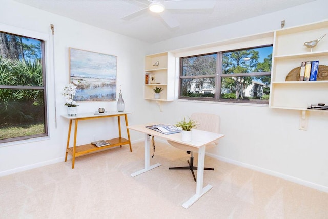 office space with light colored carpet, ceiling fan, and a healthy amount of sunlight