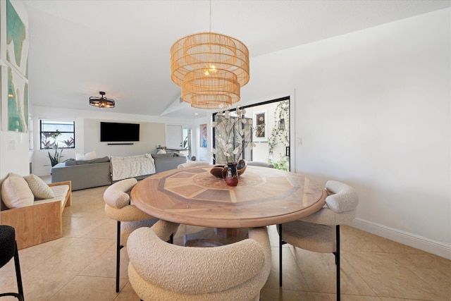 dining room featuring light tile patterned floors and a chandelier