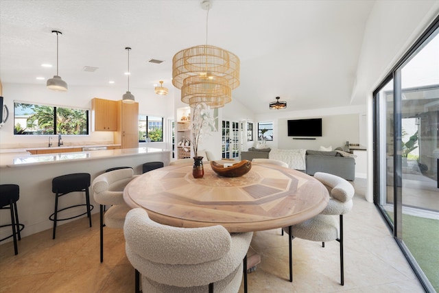 dining space featuring light tile patterned floors, vaulted ceiling, and a notable chandelier