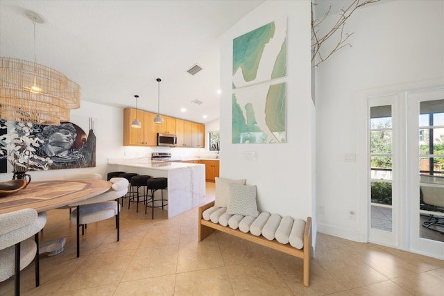 interior space featuring lofted ceiling and light tile patterned flooring