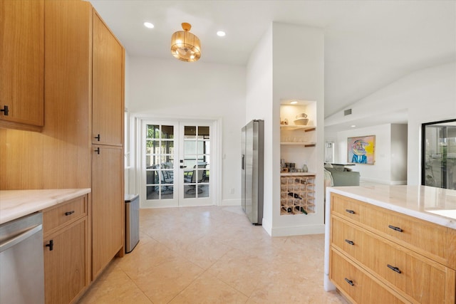 kitchen with light tile patterned flooring, stainless steel appliances, and vaulted ceiling