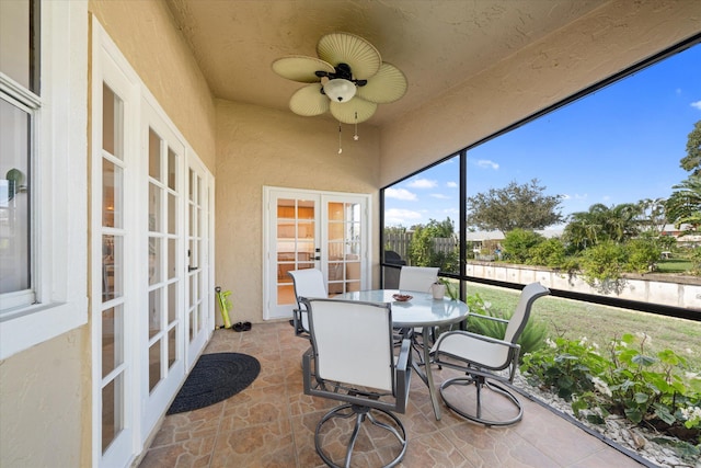 sunroom / solarium featuring french doors and ceiling fan