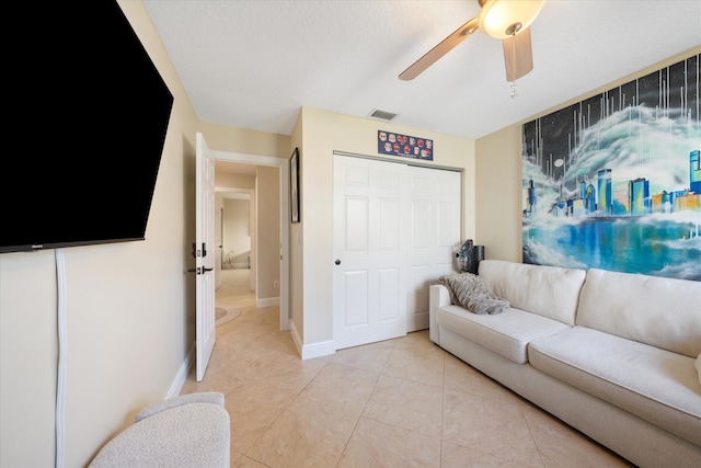 living room with ceiling fan and light tile patterned flooring